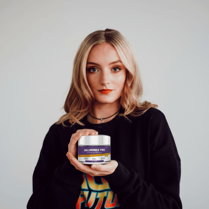 Smiling young woman holding a jar of Balmorex Pro Relief and Recovery Cream to demonstrate effective muscle recovery and fast-acting joint pain relief for active individuals.